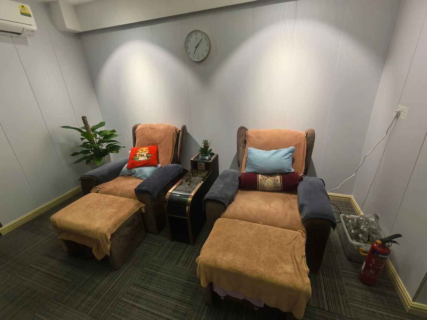 Foot reflexology room with plush reclining chairs at Apple Spa