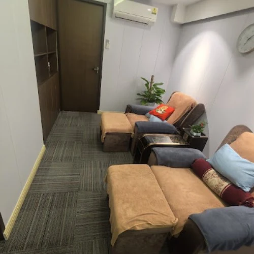 Cosy reflexology lounge with recliner sofas at Apple Spa